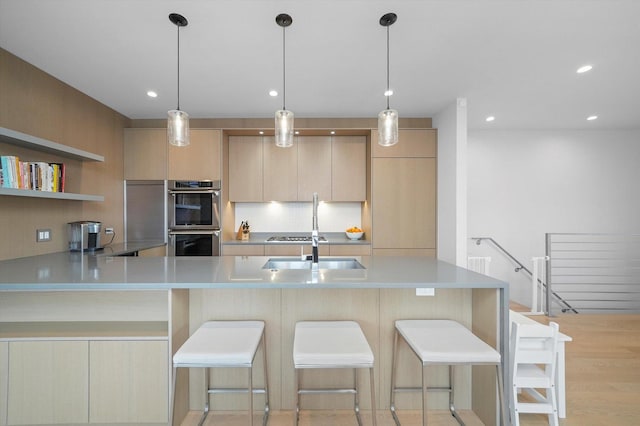 1834 N Rockwell St Unit 1R, Chicago, IL 60647 - kitchen with double oven, decorative backsplash, light countertops, modern cabinets, and a kitchen bar