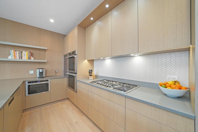 1834 N Rockwell St Unit 1R, Chicago, IL 60647 - kitchen featuring stainless steel appliances, light brown cabinets, modern cabinets, light countertops, and tasteful backsplash