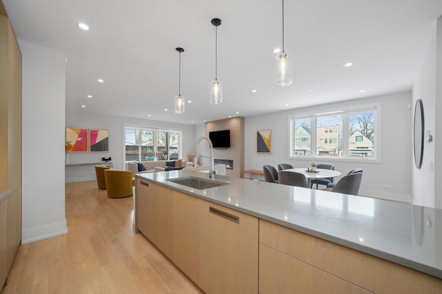 1834 N Rockwell St Unit 1R, Chicago, IL 60647 - kitchen with a sink, light wood-style floors, open floor plan, light brown cabinets, and pendant lighting