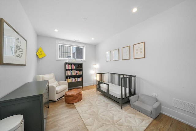 1834 N Rockwell St Unit 1R, Chicago, IL 60647 - bedroom with light wood-type flooring, a nursery area, recessed lighting, and baseboards