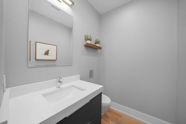 1834 N Rockwell St Unit 1R, Chicago, IL 60647 - half bath with vanity, wood finished floors, toilet, and baseboards