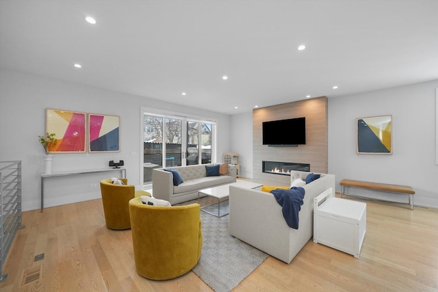 1834 N Rockwell St Unit 1R, Chicago, IL 60647 - living room with a large fireplace, light wood-style flooring, recessed lighting, and baseboards