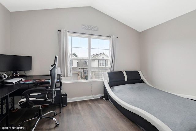 bedroom featuring vaulted ceiling and hardwood / wood-style floors