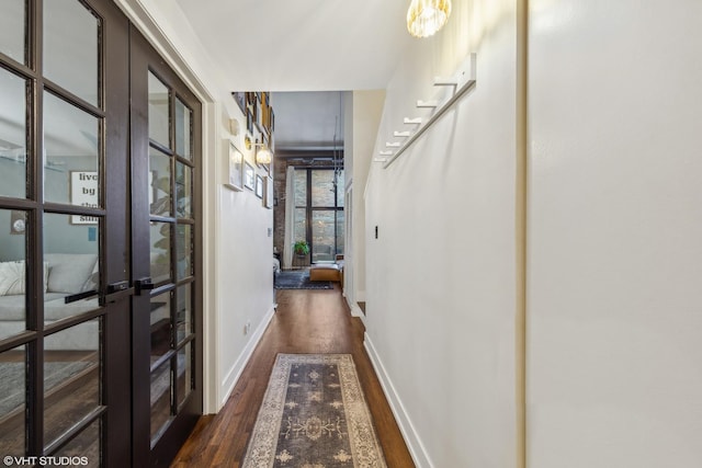 hall with french doors and dark hardwood / wood-style floors