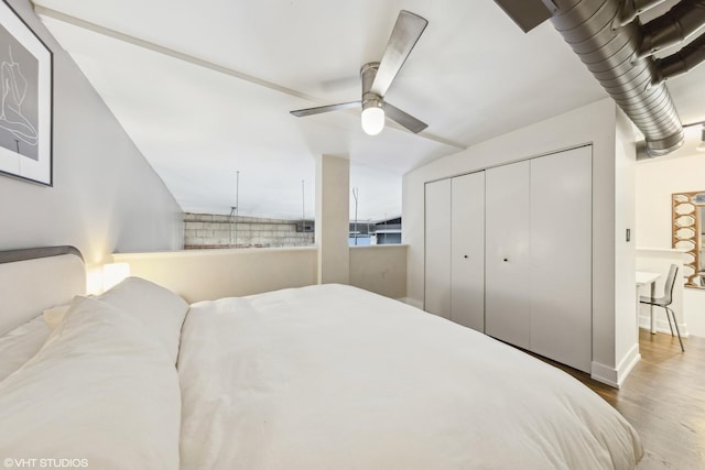 bedroom with ceiling fan, hardwood / wood-style floors, and a closet