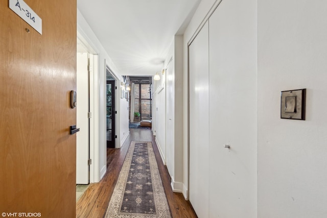 corridor featuring dark hardwood / wood-style flooring