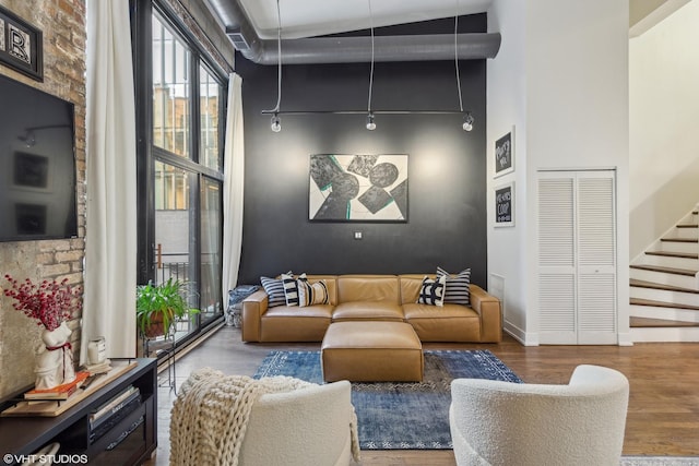 interior space with a high ceiling and hardwood / wood-style floors