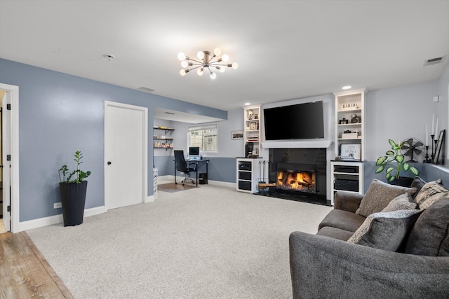 carpeted living room featuring an inviting chandelier