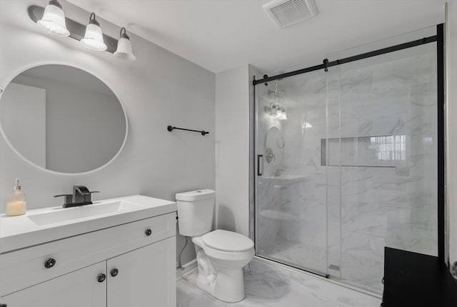 bathroom with a shower with door, vanity, and toilet