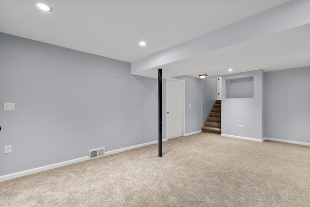 basement featuring light carpet