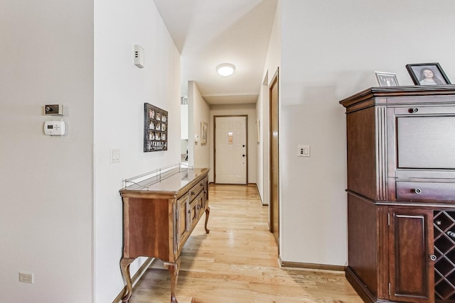 corridor with light hardwood / wood-style floors