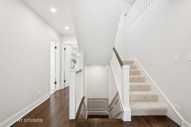 stairway featuring wood-type flooring