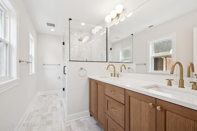 bathroom with vanity and a shower with shower door