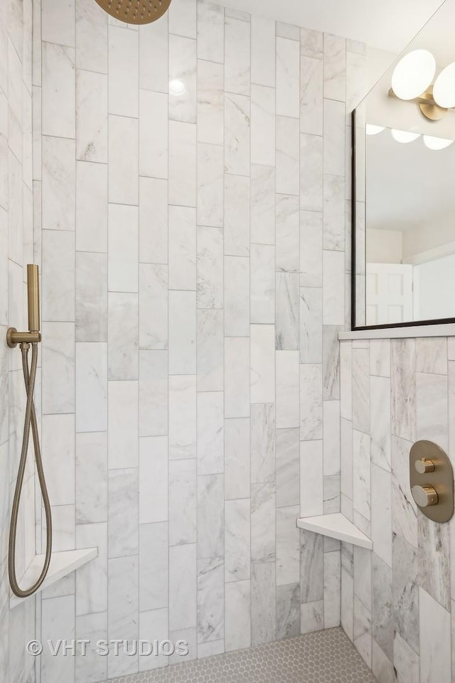 bathroom with a tile shower