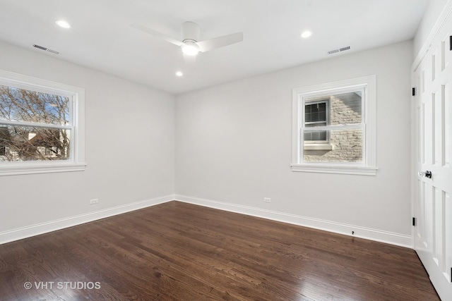 unfurnished room with dark hardwood / wood-style flooring and ceiling fan