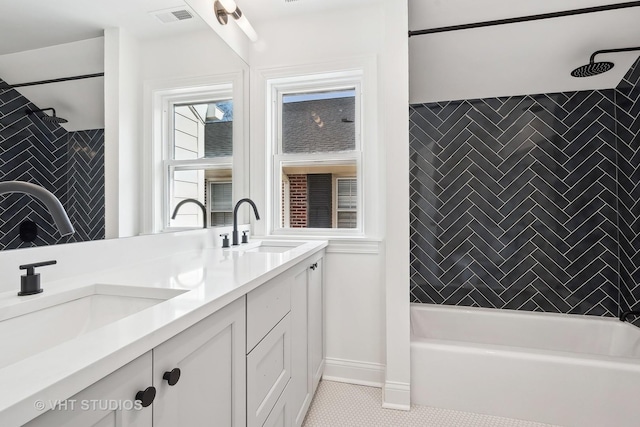 bathroom featuring vanity, tiled shower / bath combo, and tile patterned flooring