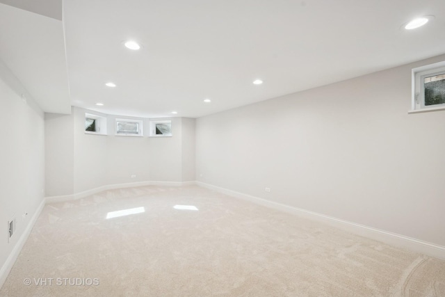 basement featuring light carpet