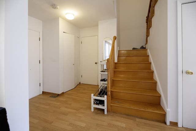 stairs featuring hardwood / wood-style flooring