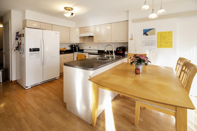 kitchen featuring light hardwood / wood-style floors, sink, white appliances, and kitchen peninsula