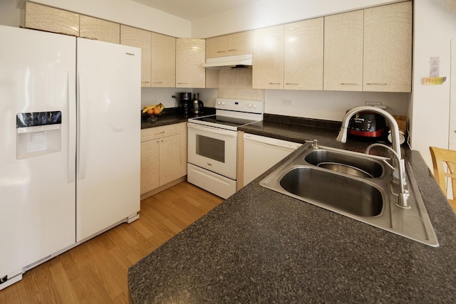 kitchen with cream cabinets, sink, white appliances, and light hardwood / wood-style flooring