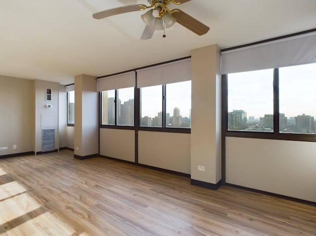 unfurnished room with a wealth of natural light and light hardwood / wood-style floors