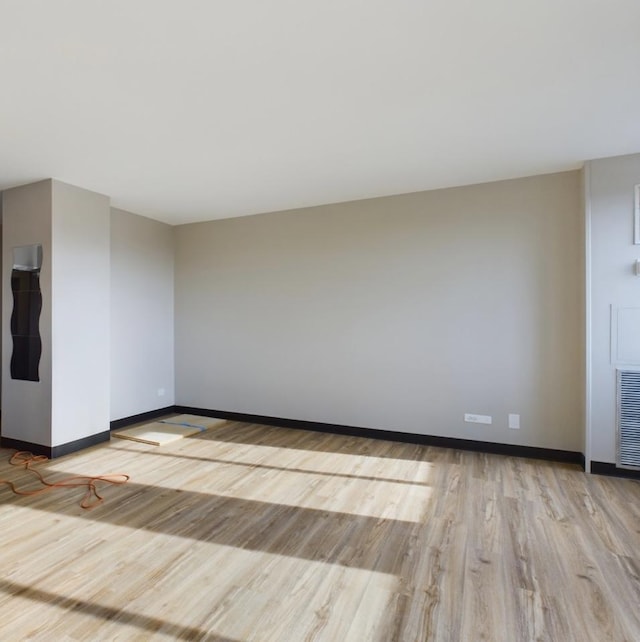 unfurnished room with light wood-type flooring