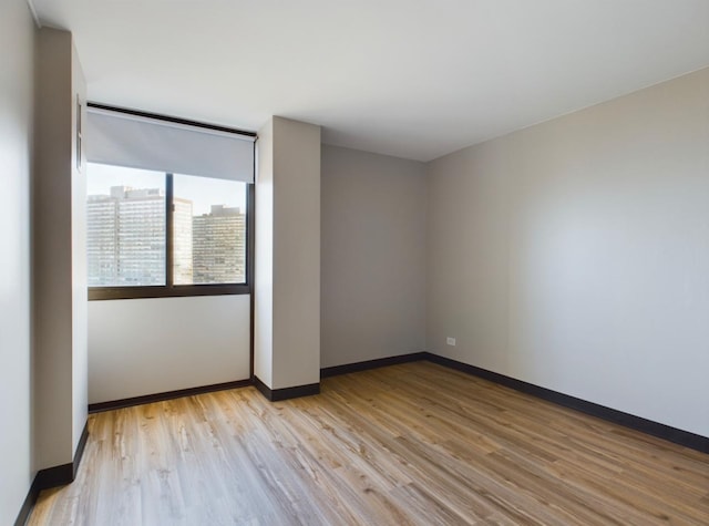 spare room with light hardwood / wood-style flooring