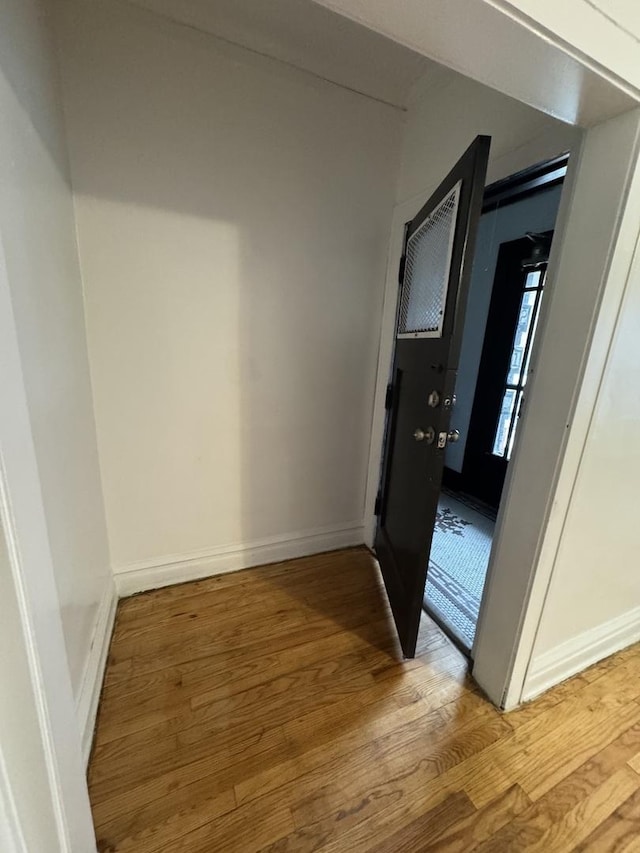 hallway with light hardwood / wood-style flooring