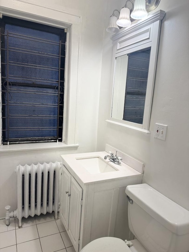 bathroom featuring sink, radiator heating unit, tile patterned floors, and toilet