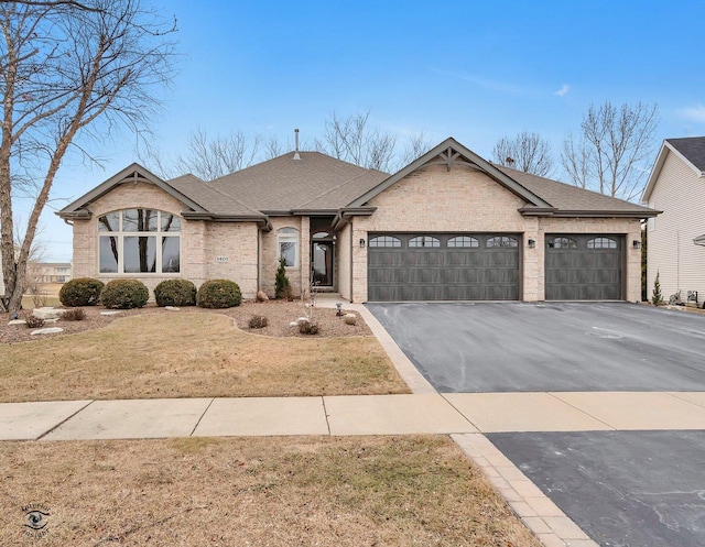 single story home with a garage and a front yard