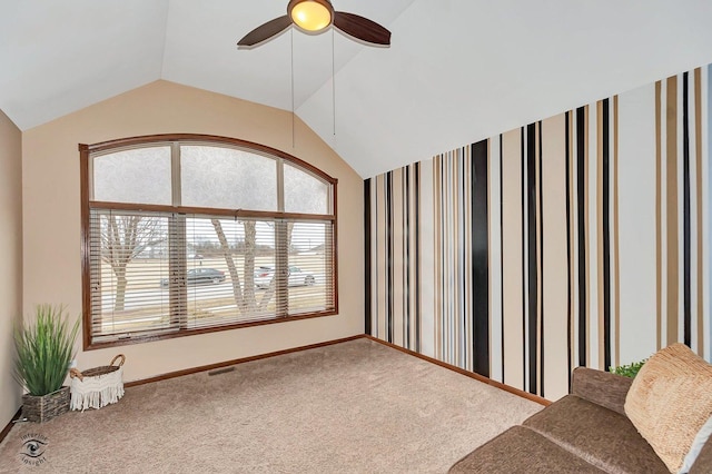 unfurnished room with vaulted ceiling, ceiling fan, and carpet