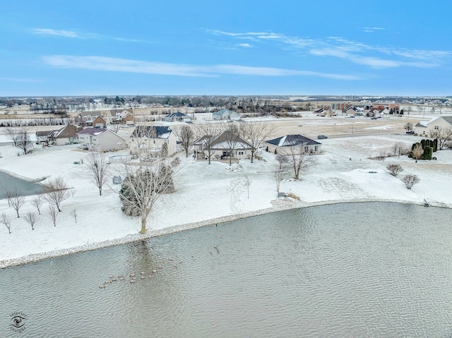 snowy aerial view featuring a water view