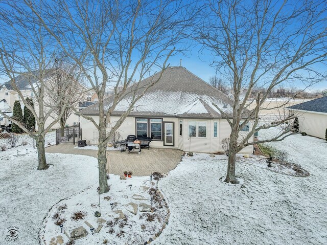 view of snow covered rear of property