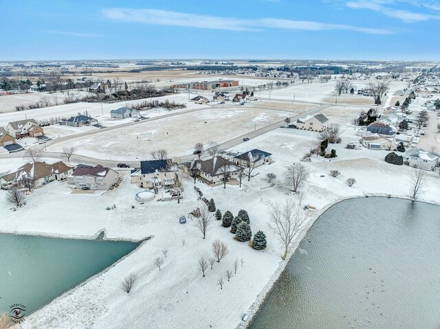 snowy aerial view featuring a water view