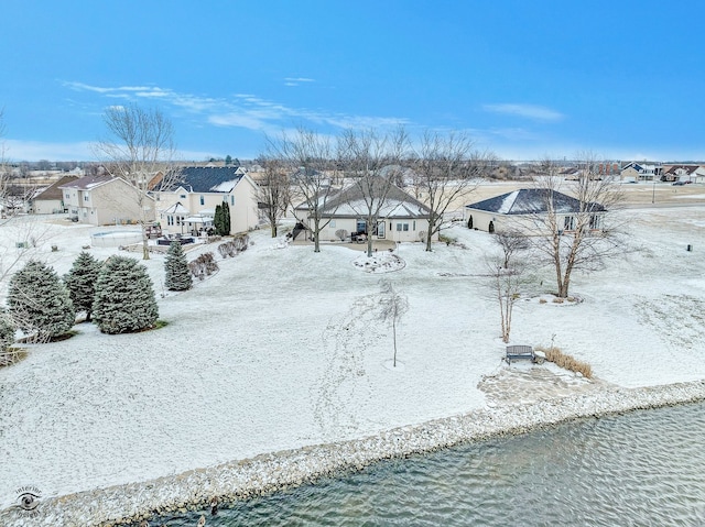 snowy aerial view featuring a water view