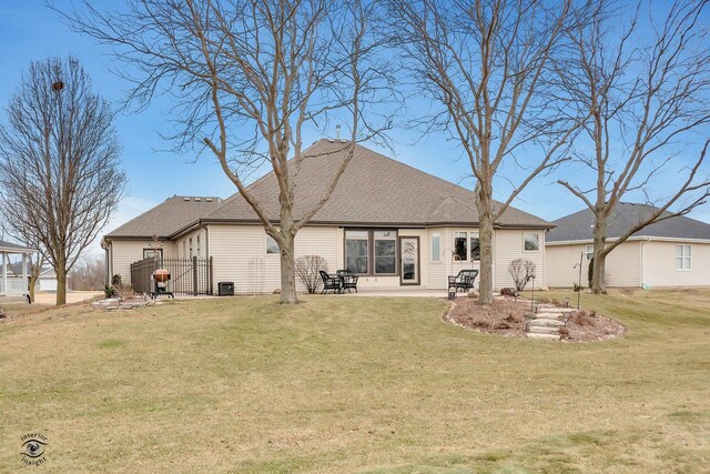 back of property with a lawn and a patio