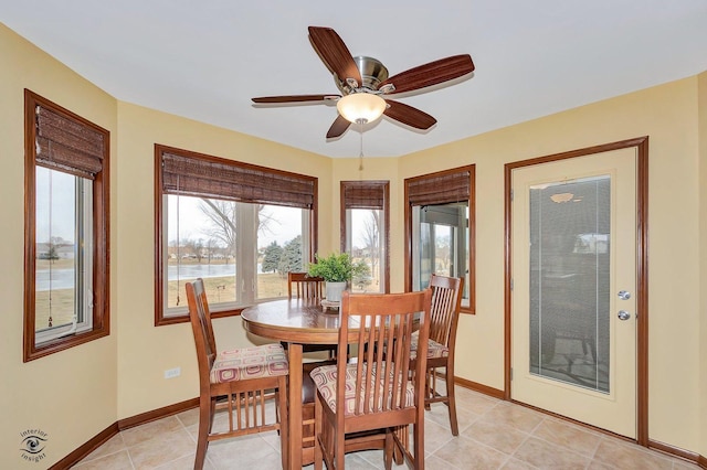 dining area featuring light tile patterned floors and ceiling fan