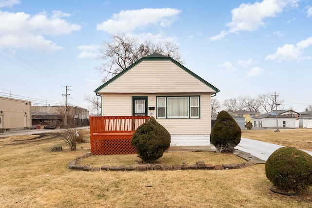 view of front of house with a deck and a front yard