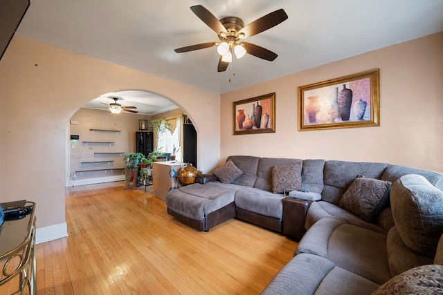 living room featuring ceiling fan and light hardwood / wood-style floors