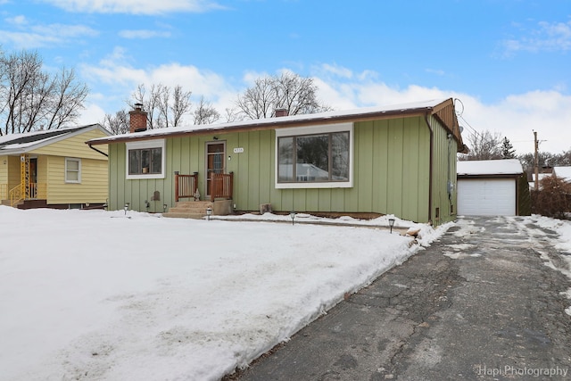 ranch-style house featuring a garage and an outbuilding