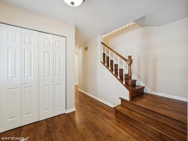 stairs with wood finished floors and baseboards