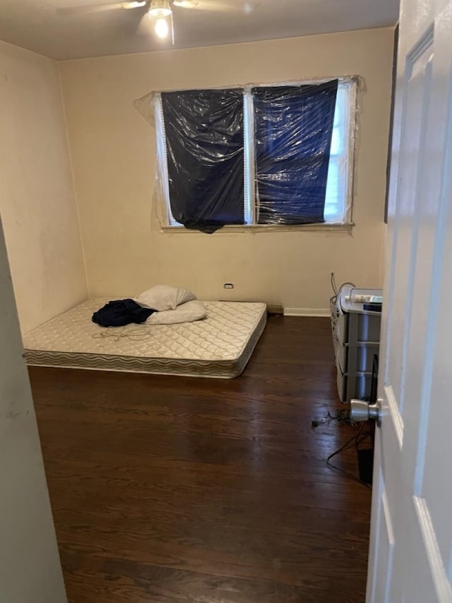 bedroom with dark wood-type flooring and ceiling fan