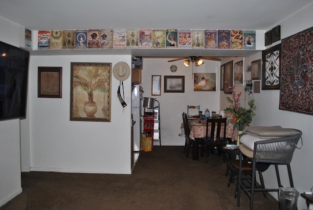 carpeted dining area with ceiling fan