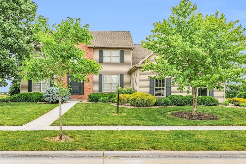 3002 Wynstone Dr, Champaign, IL 61822 - view of front facade with a shingled roof and a front lawn