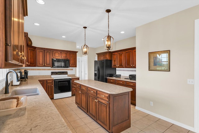 kitchen with light tile patterned floors, a sink, hanging light fixtures, black appliances, and tasteful backsplash