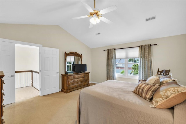 bedroom with ceiling fan, vaulted ceiling, visible vents, and light carpet