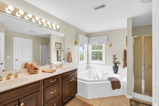 bathroom featuring tile patterned floors, visible vents, a garden tub, a stall shower, and a sink