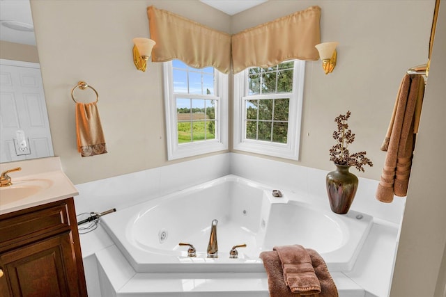 bathroom featuring a jetted tub and vanity