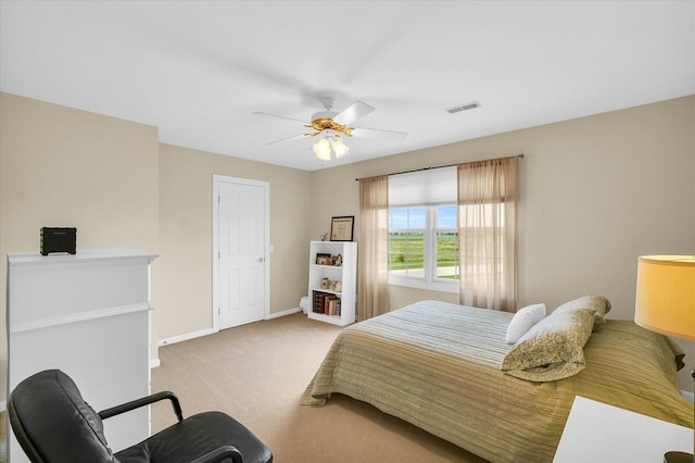 carpeted bedroom with a ceiling fan, baseboards, and visible vents