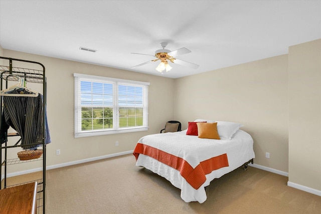 bedroom featuring visible vents, baseboards, carpet, and a ceiling fan